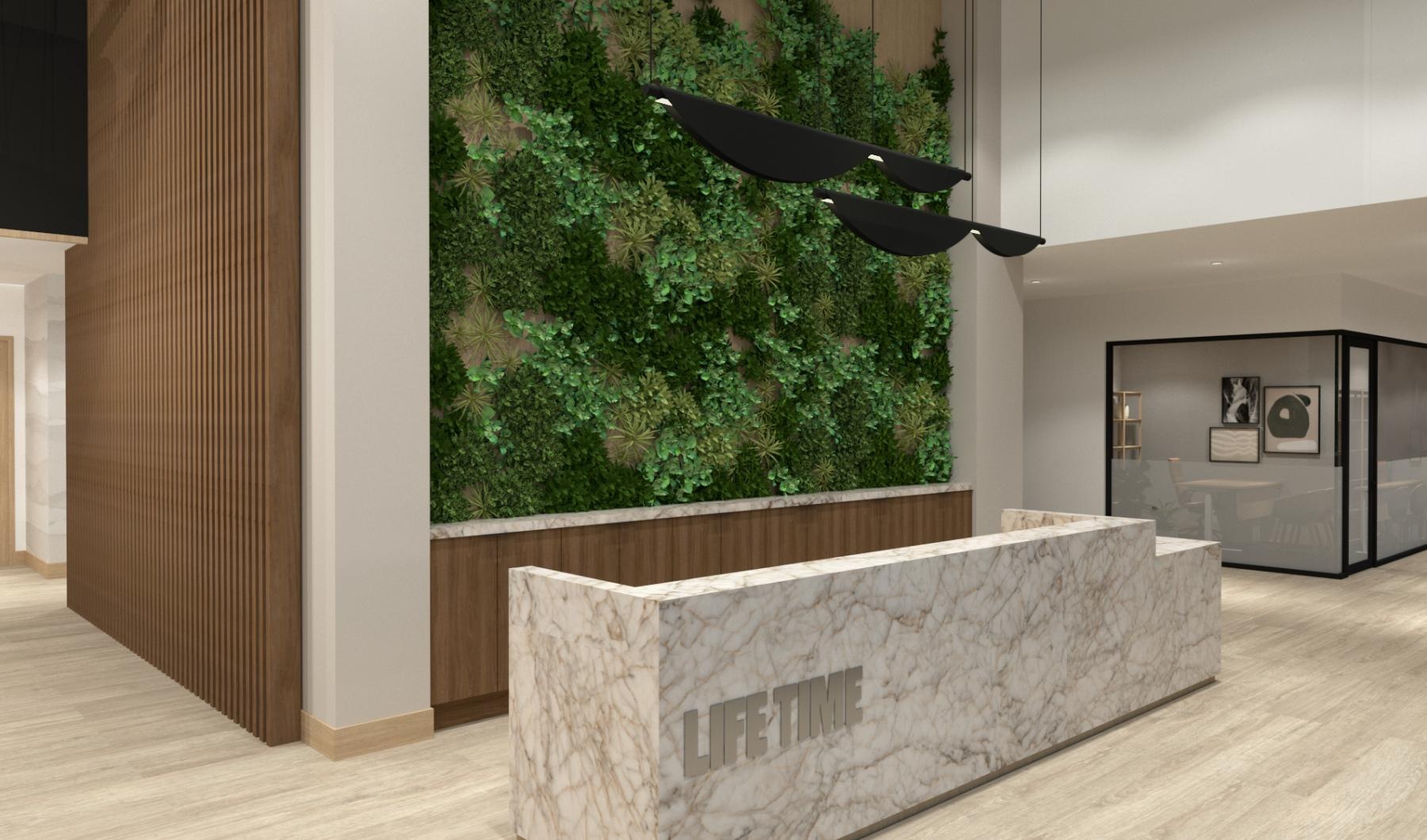 a lobby with a desk and a wall with plants on it