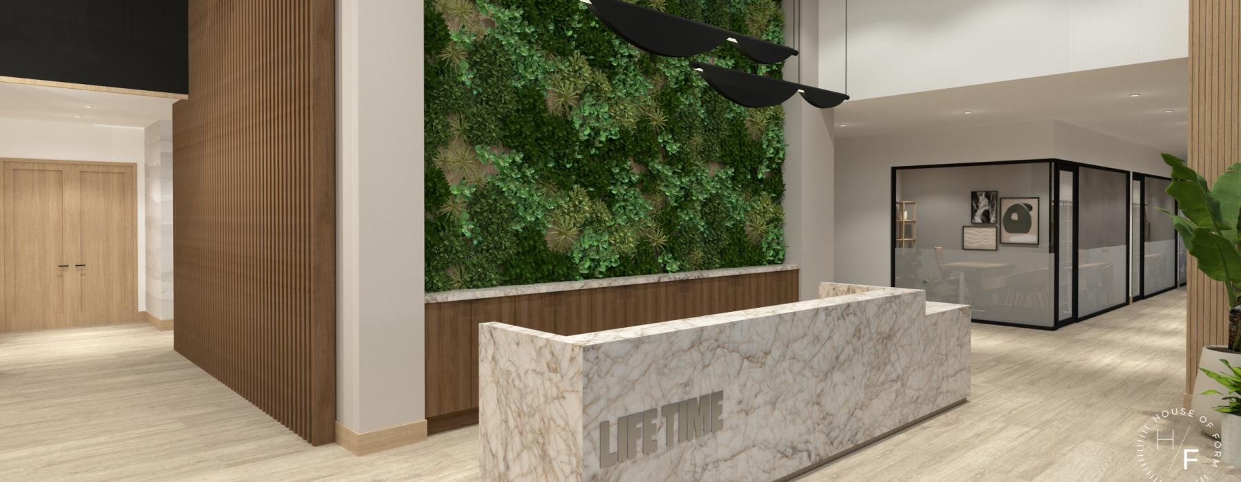 a lobby with a desk and a wall with plants on it